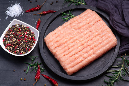 Raw Minced meat with herbs and spices,minced chicken close-up. Top view.Raw minced chicken on a...