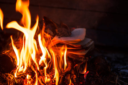 Burning pages of books. Books on fire. Background from burning books.Burning thoughts, news. Books...