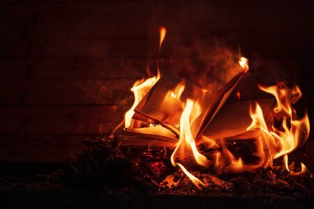 Background from burning books.Burning pages of books. Books on fire. Burning thoughts, news. Books in a red flame of fire.の写真素材