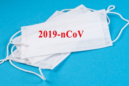 Surgical mask protective mask with text 2019-nCoV .Chinese Coronavirus, wuhan virus.Stop coronavirus warning sign.の写真素材