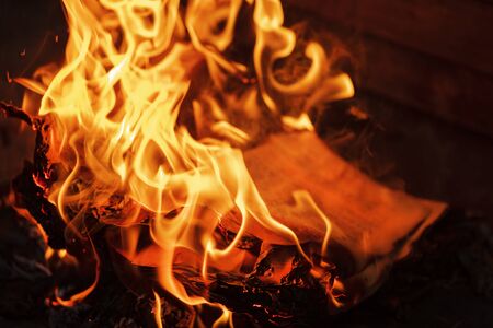 Concept for the destruction of confidential documents.Burning book on fire at night. People don't like reading.の写真素材