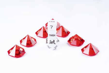 Sex dice toys Kama Sutra poses for sex games. Playing dice of red and white color for sexual games.Cube with sexy poses, Kama Sutra. Toys for adults, sex toys.の写真素材