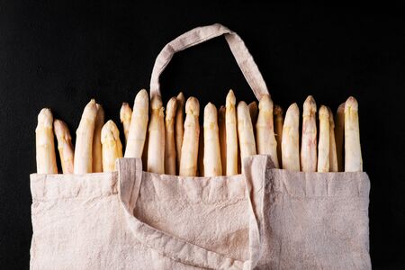 White organic asparagus in a fabric bag on a black background.Organic White Asparagus.の写真素材