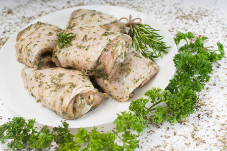 Marinated chicken thigh on a white plate on a light background. Chicken for retail.Precooked food.Convenience foods.delicious fried chicken thighの写真素材