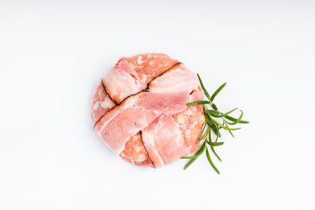 Raw chicken hamburger on a white background in a rosemary branch. Instant meat. Grilled hamburgers.Raw Hamburger, meatballs on white background.Fast food at home.Convenience food, precooked.の写真素材