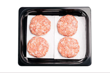 Raw Hamburger in black tray for retail. fast cooking at home. Fast food.Raw Hamburger, meatballs in black plastick tray isolated on white background.の写真素材