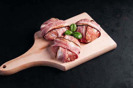 Grilled hamburgers.Copy space.Raw chicken burger on a wooden kitchen board and spices. Instant meat.の写真素材