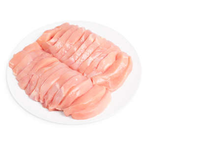 Raw chicken medallions on a white plate on an isolated background with rosemary leaves. Raw chicken meat. Raw chicken steaks.の写真素材