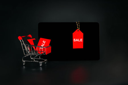 Sale on Black Friday. Banner, poster.Shopping cart on a black background.Sale, discount, shopaholism...