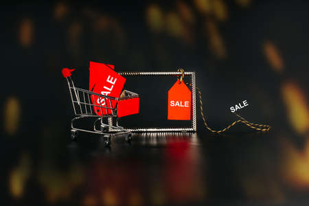 Sale on Black Friday. Banner, poster.Shopping cart on a black background.Sale, discount, shopaholism concept.の写真素材
