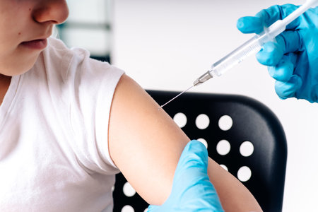 The child was given a vaccine.Female doctor or nurse trying to give shot or vaccine against virus to a scared patient. Angry and distrustful patient refuses to receive it.Vaccinations for children.の写真素材