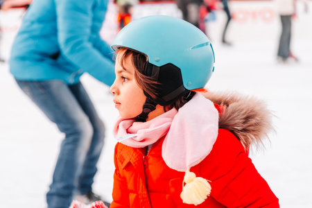 Slovakia - Bratislava 05.01.2020: Enjoying winter outdoor activities. Outdoor. Group of teenage friends ice skating on an ice rink. Winter sport. People ice skating on the City Park Ice Rink in Europe.のeditorial素材