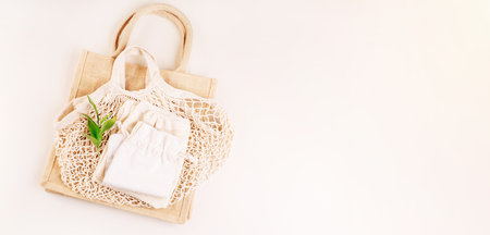 A variety of eco bags on a yellow background.Sustainable lifestyle.Eco Bags.Zero waste minimal composition with tring and canvas bags for storage.Zero waste, eco friendly shopping. Top view, flat lay.の写真素材