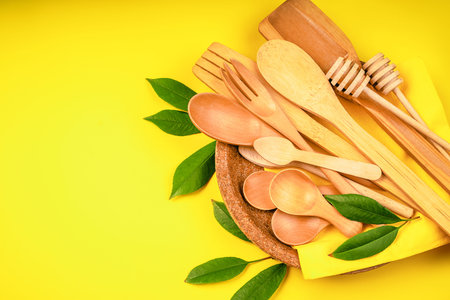 Eco-friendly disposable utensils made of bamboo wood and paper Draped spoons, fork, knives, bamboo...
