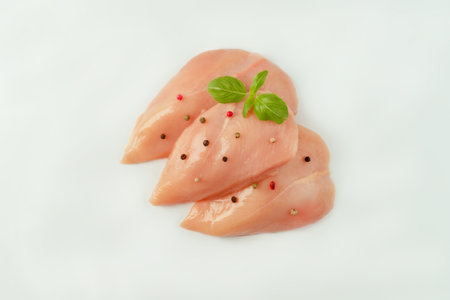 Chicken breast Fillets.Close up.Raw chicken meat.Raw fresh chicken fillet light background with fresh herbs.Food for retail.Procurement for designers.Ogranic food,healthy eating.Food concept.Top view.の写真素材