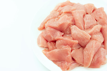 Raw chicken.Frozen chicken fillet..Ogranic food and healthy eating.frozen turkey or poultry meat.Fresh frozen pieces of turkey meat on a white background.の写真素材