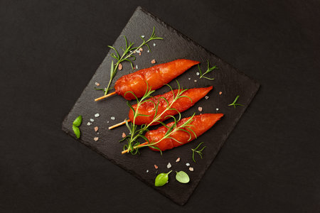 Fresh raw marinated chicken meat skewers iner fillet with fresh herbs on a black background.Chicken...