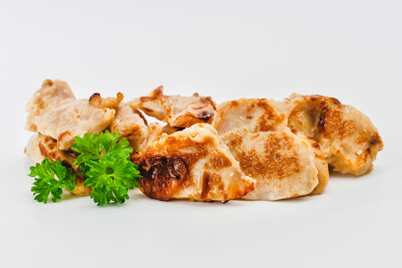 Chicken fillets fried until half cooked, semi-finished product with fresh herbs on a white background. Fast cooking.Fast homemade food.Fast food. Quick cooking at home. Copy space.の写真素材