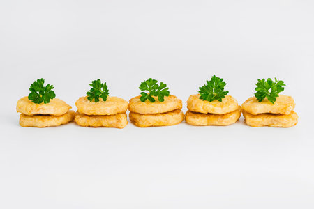 Chicken Breaded Fillet.Fast food. Breaded Chicken Inner Fillet on a White Background,Chicken Breaded Raw Meat. Fast cooking. Breaded chicken nuggets. Homemade food at home.の写真素材