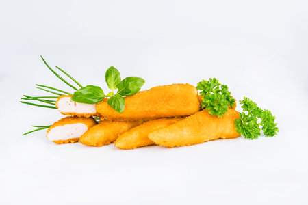 Breaded Chicken Inner Fillet, Chicken Breaded Raw Meat. Fast cooking.Breaded Chicken nuggets Fillet with salad on a White Background,food at home. Fast homemade food.Chicken breaded schnitzels.の写真素材
