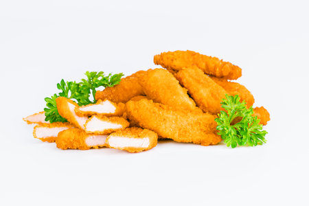 Breaded Chicken Inner Fillet, Chicken Breaded Raw Meat. Fast cooking.Breaded Chicken nuggets Fillet with salad on a White Background,food at home. Fast homemade food.Chicken breaded schnitzels.の写真素材