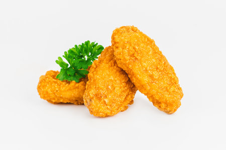 Semi-finished product, fried wings.Breaded Chicken wings with salad on a White Background,food at home.Fast homemade food.Chicken Breaded Raw Meat. Fast cooking.の写真素材