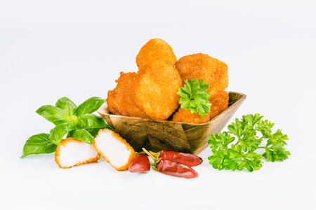 Breaded Chicken Inner Fillet, Chicken Breaded Raw Meat. Fast cooking.Breaded Chicken nuggets Fillet with salad on a White Background,food at home. Fast homemade food.Chicken breaded schnitzels.の写真素材