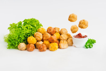 Fast food.Levitation, breaded chicken nuggets, semi-finished product with fresh herbs on a white background. Quick cooking at home. Copy space.の写真素材