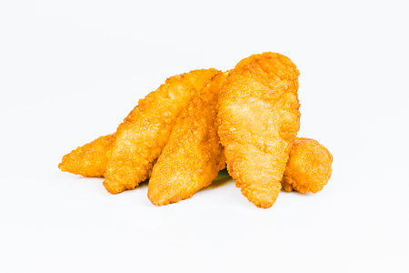 Breaded Chicken Inner Fillet on a White Background,Chicken Breaded Raw Meat.Chicken Breaded Fillet.Fast food. Fast cooking. Breaded chicken nuggets. Homemade food at home.の写真素材