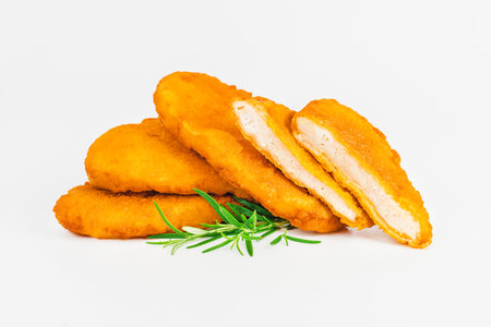 Breaded Chicken Inner Fillet, Chicken Breaded Raw Meat. Fast cooking.Breaded Chicken nuggets Fillet with salad on a White Background,food at home. Fast homemade food.Chicken breaded schnitzels.の写真素材
