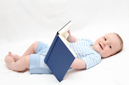 baby reading a book on backの写真素材