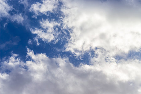 Beautiful blue sky background with cumulus clouds. Sunlight.