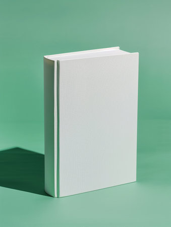 Minimal white hardcover book mockup standing vertically. Studio setup with solid background. Blank book cover. Design for invitation, postcard, banner, poster. High qualityの素材