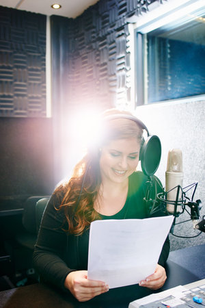 Shot of a young woman working in a recording studioの写真素材