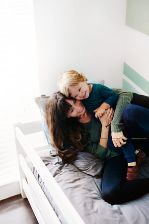 Cropped shot of a young woman spending quality time at home with her son