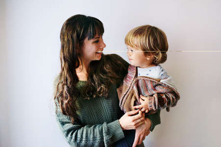 Cropped shot of a young woman spending quality time at home with her sonの写真素材