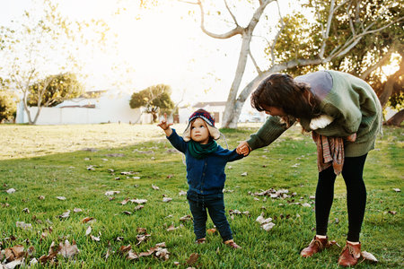 Shot of a single mother spending some time at the park with her son
