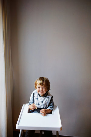 Shot of an adorable little boy sitting in his high chair