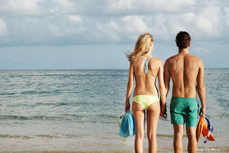 Shot of a young couple spending the day at the beachの写真素材