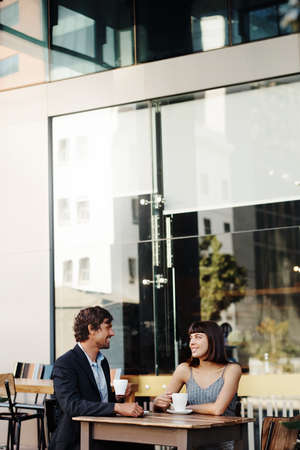 Shot of a young couple on a coffee date at a sidewalk cafeの写真素材