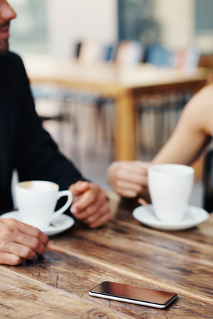 Cropped shot of an unrecognizable couple out on a date at a coffee shopの写真素材