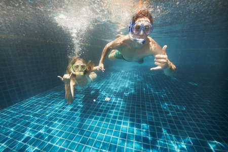 young couple enjoying some time in the pool while on vacationの写真素材