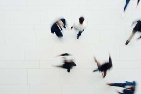 High angle shot of a group of businesspeople walking in an officeの写真素材