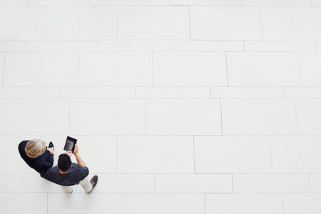 High angle shot of two businesspeople using a digital tablet together