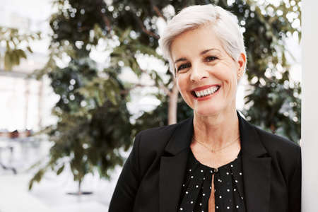 Portrait of a confident mature businesswoman standing in a convention centerの写真素材