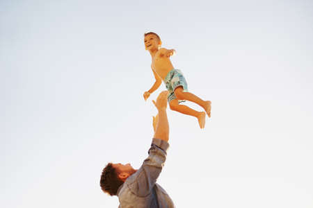 Shot of a father bonding with his little son at the beachの写真素材