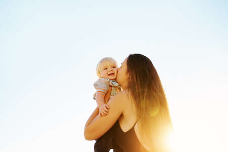 Shot of a mother bonding with her little son at the beachの写真素材