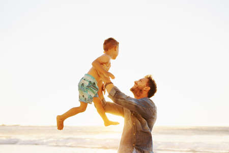 Shot of a father bonding with his little son at the beachの写真素材