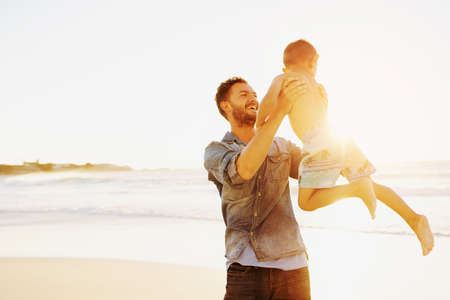 Shot of a father bonding with his little son at the beachの写真素材