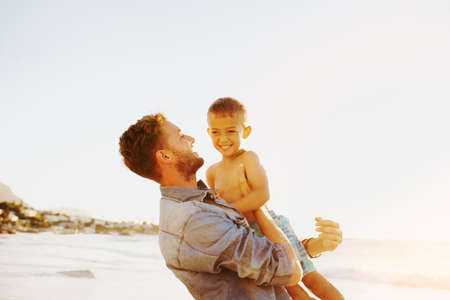 Shot of a father bonding with his little son at the beachの写真素材